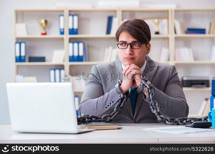 Businessman tied with chains to his work