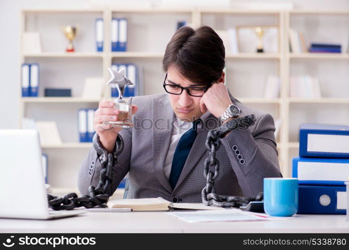 Businessman tied with chains to his work