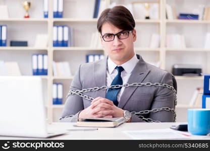 Businessman tied with chains to his work