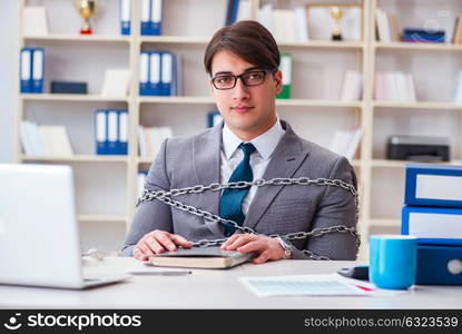 Businessman tied with chains to his work