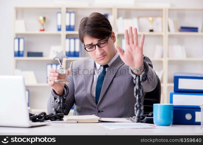 Businessman tied with chains to his work