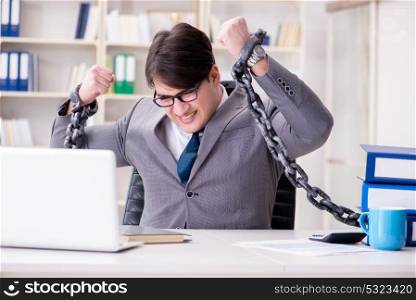 Businessman tied with chains to his work. The businessman tied with chains to his work