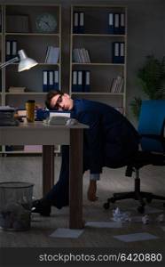 Businessman tired and sleeping in the office after overtime hours