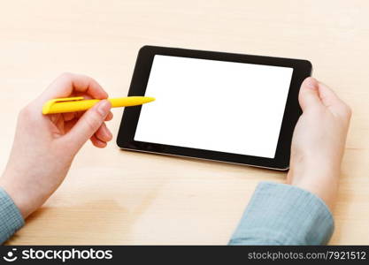 businessman touches by pen of tablet PC with cutout screen at office table