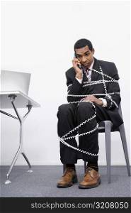 Businessman trapped in a wire of a telephone