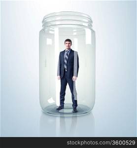 Businessman trapped inside a transparent glass jar