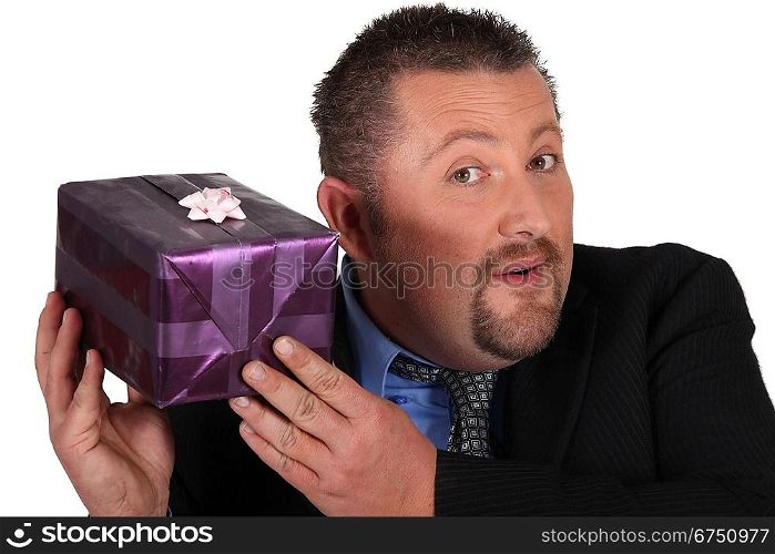 Businessman trying to guess what&acute;s inside his gift