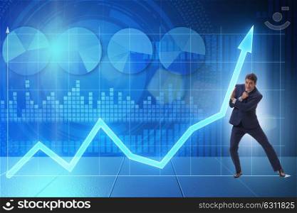 Businessman trying to help economic growth in business concept. The businessman trying to help economic growth in business concept