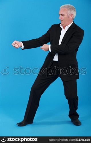 Businessman tugging invisible rope