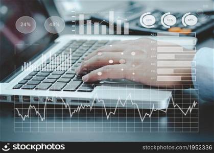 businessman typing computer laptop on desk. chart and graph virtual screen hologram. business technology concept