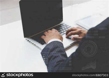businessman typing on laptop computer in office workplace