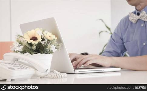 businessman typing on laptop in an office