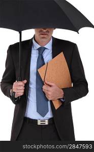 Businessman under an umbrella