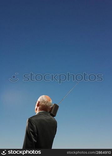 Businessman Under Clear Sky Listening to Radio