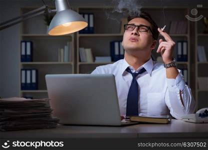 Businessman under stress smoking in office