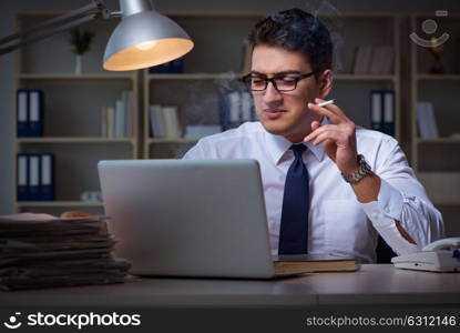 Businessman under stress smoking in office. The businessman under stress smoking in office