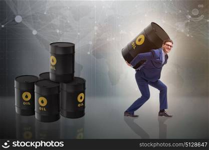 Businessman under the burden of oil barrel
