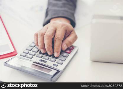 Businessman using a calculator to calculate the numbers. Accounting
