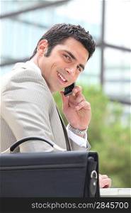 Businessman using a cellphone outside