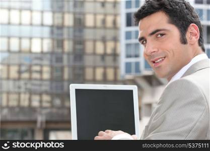 Businessman using a laptop with a blank screen