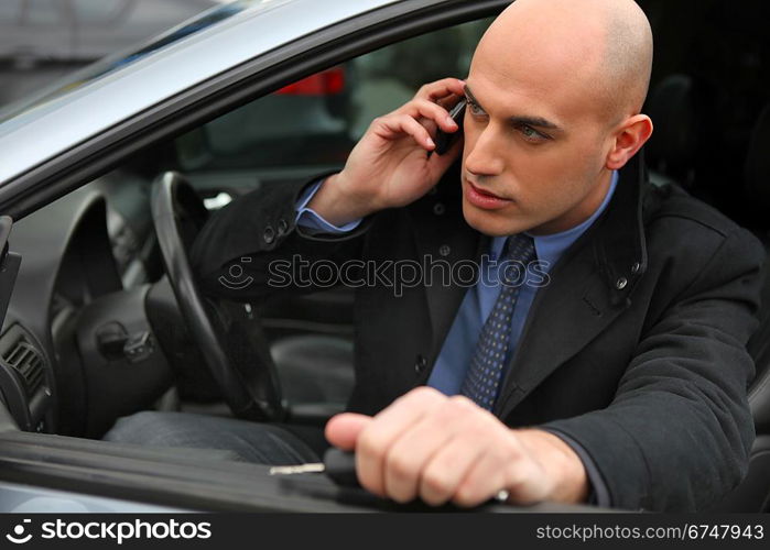 Businessman using a phone in his car