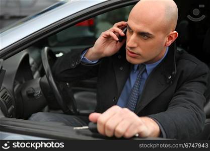 Businessman using a phone in his car