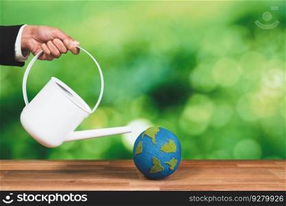 Businessman using a watering can to nourish earth globe with tree, representing corporate reforestation policy for sustainable future. Forest regeneration and ecological recovery concept. Alter. Businessman using a watering can to nourish earth globe with tree. Alter