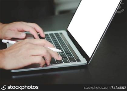 businessman using and typing on laptop with blank white screen mock up.