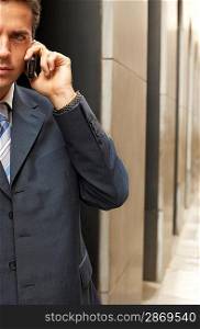 Businessman Using Cell Phone Outside Office Building