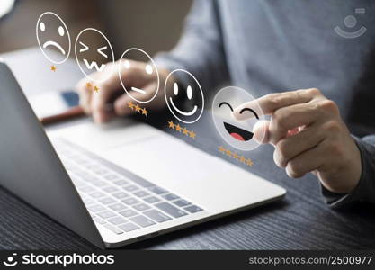 Businessman using computer laptop with popup rating icon for feedback review , Customer give rating to service experience on online application for giving best score