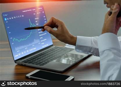 Businessman using computer notebook trading online investment