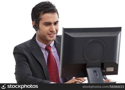Businessman using computer while on call