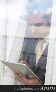 Businessman using digital tablet in office