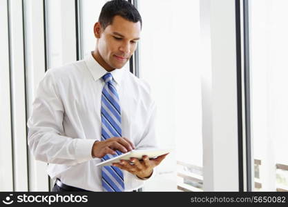 Businessman Using Digital Tablet In Office