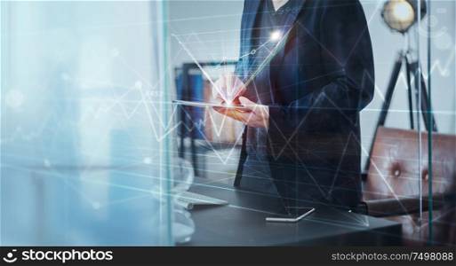 Businessman using digital tablet to analysis market sales growth thru virtual screen . Ecommerce marketing concept .