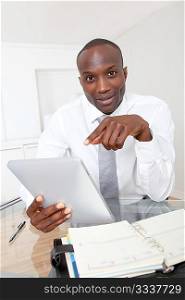 Businessman using electronic tablet in office