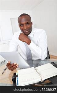 Businessman using electronic tablet in office