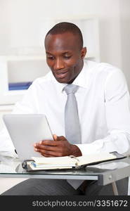 Businessman using electronic tablet in office