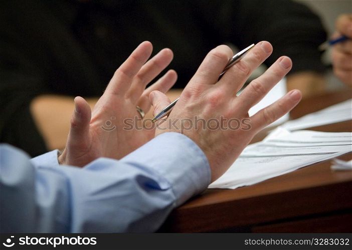 Businessman using his hands to speak in meeting.