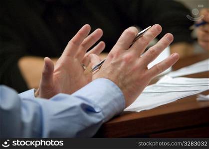 Businessman using his hands to speak in meeting.