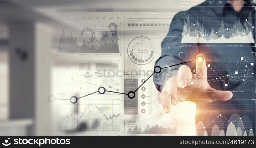 Businessman using innovative technologies. Close up of businessman touching virtual panel with finger