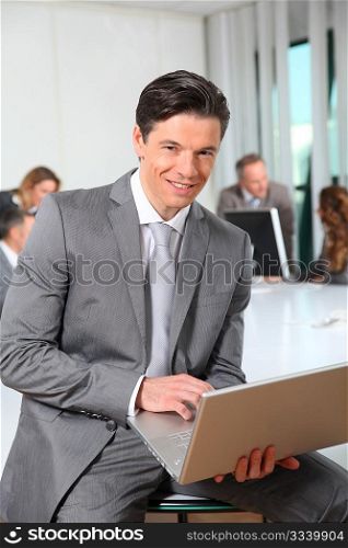 Businessman using laptop computer in office