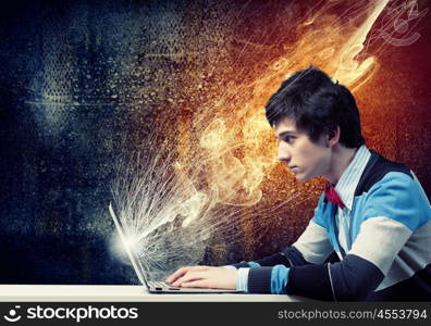 Businessman using laptop. Image of young businessman at work using laptop