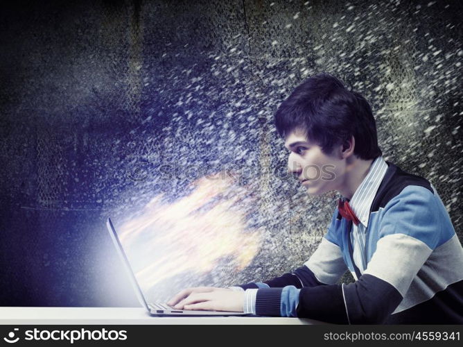 Businessman using laptop. Image of young businessman at work using laptop