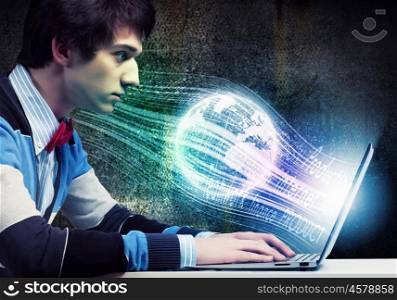 Businessman using laptop. Image of young businessman at work using laptop