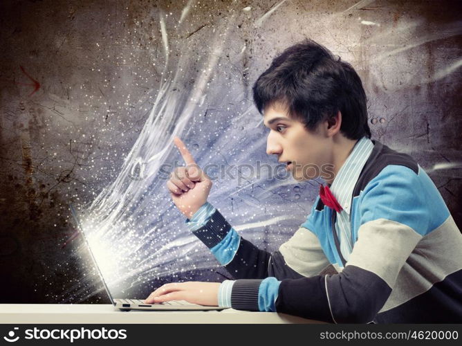 Businessman using laptop. Image of young businessman at work using laptop