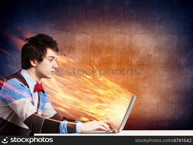 Businessman using laptop. Image of young businessman at work using laptop