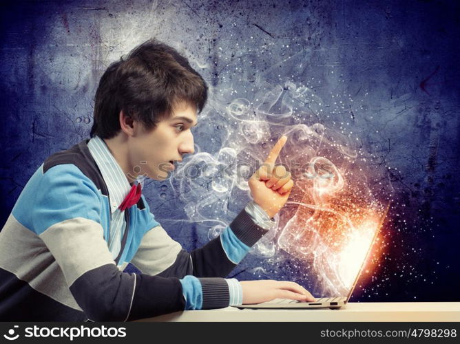 Businessman using laptop. Image of young businessman at work using laptop