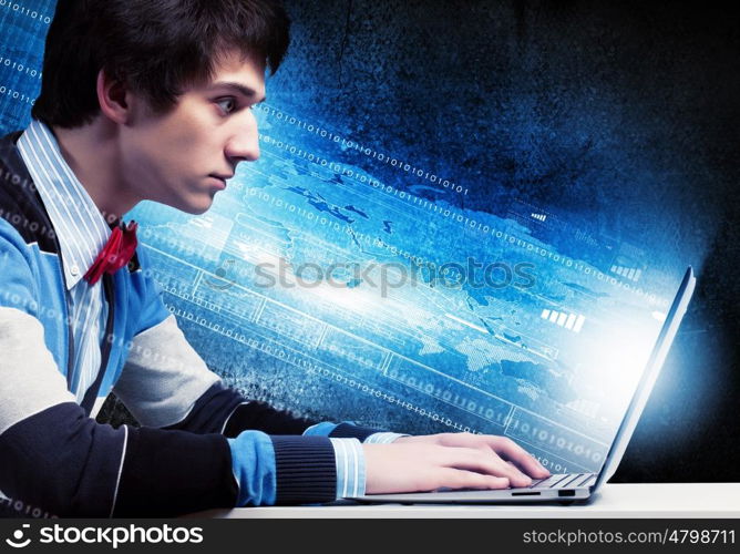 Businessman using laptop. Image of young businessman at work using laptop