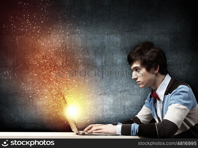 Businessman using laptop. Image of young businessman at work using laptop